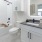 A bathroom with a tub, sink, and toilet in a clean, modern design