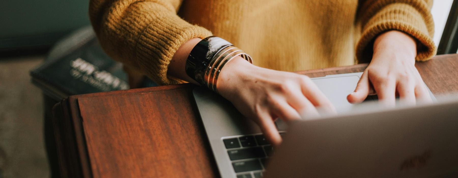 woman typing on a laptop keyboard